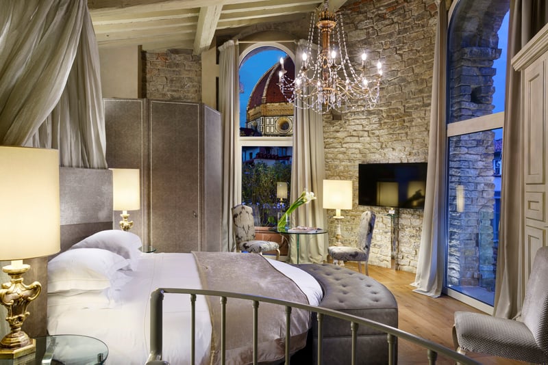 The interior of a Brunelleschi suite bedroom that looks out onto the Duomo