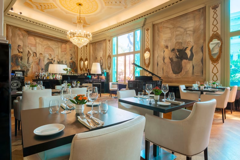 The interior of the Cadorin Restaurant & Lounge with the frescoes of Venetian painter Guido Cadorin